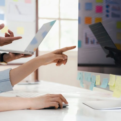 Team of developer programmer working on project in software development computer in IT company
