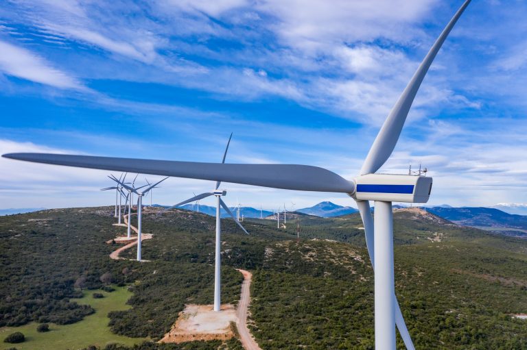 Wind turbines, renewable energy on a green hill. Wind farm