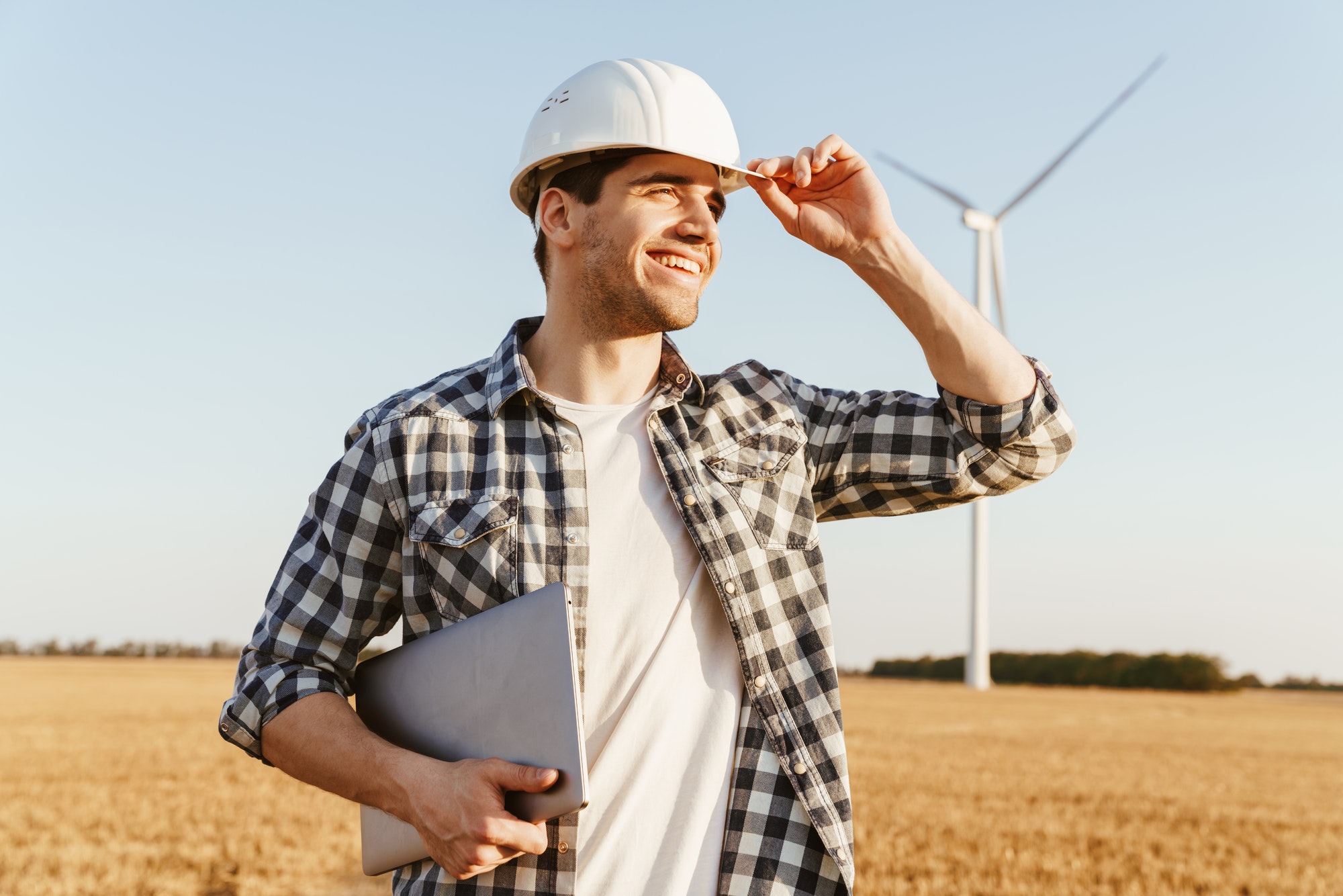 An electrical engineer standing on a field