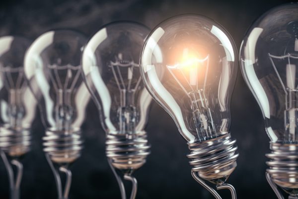Row of light bulb with a one glowing. Idea and innovation concept.